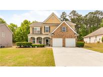 Charming two-story home with a brick and siding facade, two-car garage, and well-manicured lawn at 3060 Elmwood Ct, College Park, GA 30349