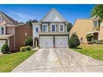 Charming two-story home with a two-car garage and beautiful landscaping, perfect for families at 7705 Bellmist Dr, Fairburn, GA 30213