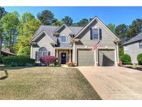 Charming two-story home with a well-manicured lawn and two-car garage at 192 Adelaide Xing, Acworth, GA 30101