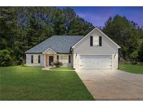 Charming single-Gathering home featuring a well-manicured lawn, attached two car garage, and traditional design at 220 Rocky Point Rd, Covington, GA 30014