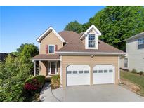 Charming two-story home with attached two car garage and well-maintained landscaping at 877 Ashwood Walk, Decatur, GA 30030