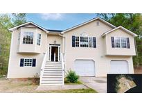 Charming two-story home featuring a two-car garage, bay windows, and traditional design at 645 Woodwind Dr, Rockmart, GA 30153