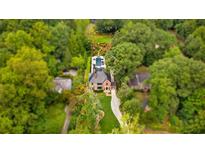 Stunning aerial view of estate home with lush landscaping and backyard pool at 808 Lullwater Ne Rd, Atlanta, GA 30307