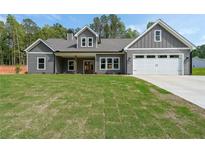 Charming craftsman-style home with gray siding, a manicured lawn, and an attached two-car garage at 82 Lexie Court, Rockmart, GA 30153