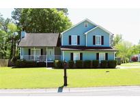 Charming two-story home with a well-manicured lawn and inviting front porch at 3420 Caley Mill Ln, Powder Springs, GA 30127