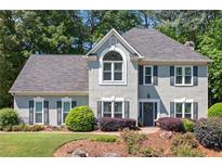 Charming two-story traditional home with a well-manicured lawn and beautiful landscaping at 2009 Westside Ln, Woodstock, GA 30189