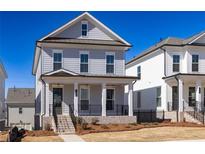 Charming two-story home with a covered front porch, neat landscaping, and classic architectural details at 171 Basil Street Dr, Cumming, GA 30040