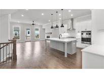 Modern kitchen with large island, stainless steel appliances, and an open floor plan at 171 Basil Street Dr, Cumming, GA 30040