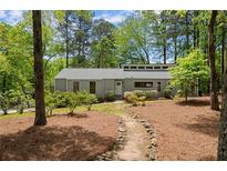 Charming home with a landscaped front yard, mature trees and walkway leading to the front door at 3510 Holliglen Dr, Marietta, GA 30062