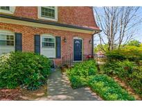 Charming brick townhouse with a well-maintained front yard and black door at 1261 Lavista Ne Rd # J-4, Atlanta, GA 30324