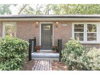 Charming brick home entrance with a decorative front door, brick path and lush landscaping at 3207 Canary Ct, Decatur, GA 30032