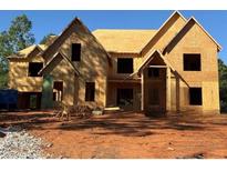 Two story home with a multi-gabled roofline and exposed wood frame at 409 Thunder Rd, Buford, GA 30518