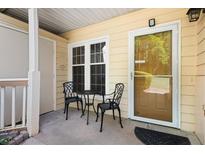 Inviting front porch with table and chairs, perfect for relaxing outdoors at 2605 Vineyard Se Way, Smyrna, GA 30082