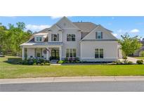 Beautiful two-story home with a manicured front yard and inviting front porch at 6420 Beacon Station Dr, Cumming, GA 30041