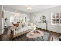 Bright living room with white walls, hardwood floors, neutral sofa, and floods of natural light at 1612 Alder Se Ct, Atlanta, GA 30317