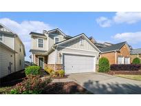 Charming two-story home with a two-car garage, stone accents, and landscaped front yard at 2206 Palomino Ln, Conyers, GA 30012