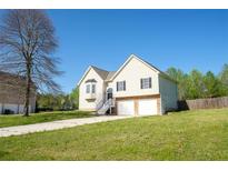 Charming home with a two-car garage, complemented by a well-maintained lawn and classic design elements at 186 Majesty Dr, Rockmart, GA 30153