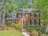 Charming two-story brick home with manicured landscaping and a welcoming front entrance at 2885 Arborwoods Dr, Alpharetta, GA 30022