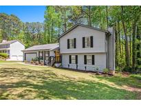 Charming two-story home with a well-manicured lawn and mature trees in a serene neighborhood at 2022 Ramblewood Ne Ct, Marietta, GA 30062