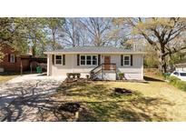 Charming single-story home featuring a well-maintained lawn and inviting front porch with classic curb appeal at 2215 Gordon Se Cir, Smyrna, GA 30080