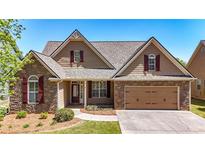 Charming home featuring stone accents, a two-car garage, well-manicured lawn, and a welcoming entrance at 28 Summer Nw Pl, Cartersville, GA 30121