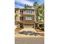 Charming townhouse with a neutral color scheme, brick accents, and a two-car garage at 2808 White Oak Ln, Decatur, GA 30032
