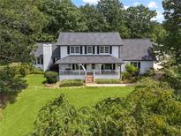 Charming two-story home with a welcoming front porch and well-manicured lawn at 269 Red Gate Dr, Canton, GA 30115