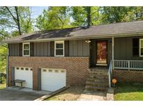 Charming two-story home featuring a brick facade and two-car garage at 3105 Sumac Dr, Atlanta, GA 30360