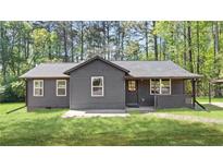 Charming single-story home with a well-maintained lawn and inviting covered front porch at 3917 Dallas Acworth Nw Hwy, Acworth, GA 30101