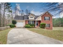 Charming two-story home with brick and siding exterior, landscaping, and driveway at 2591 Boulder Hill Se Ct, Atlanta, GA 30316