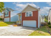 Charming two-story home with red brick accents and an attached one car garage at 3721 Longview Dr, Douglasville, GA 30135