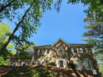 Charming two-story home exterior with beautiful architectural details and manicured landscaping at 7635 Blandford Pl, Atlanta, GA 30350