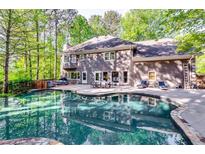 Backyard pool featuring well-maintained landscaping, hot tub, and outdoor seating at 7635 Blandford Pl, Atlanta, GA 30350