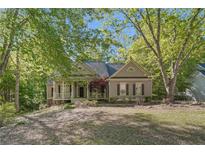 Charming single-story home featuring a welcoming front porch and beautiful, mature landscaping at 160 Winter Park Ln, Powder Springs, GA 30127