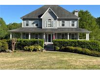 Charming two-story home with a welcoming front porch and a well-manicured lawn at 33 Ashland Cir, Douglasville, GA 30134