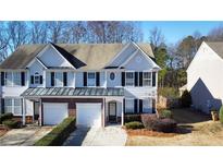 Charming townhome with a two-car garage, black shutters, and an inviting entrance at 3723 Verde Glen Ln, Cumming, GA 30040