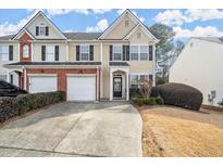 Charming townhouse with two-car garage, manicured landscaping, and inviting front entrance at 3723 Verde Glen Ln, Cumming, GA 30040