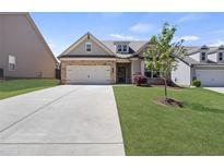 Charming single-Gathering home with a two-car garage and well-manicured lawn in a suburban neighborhood at 238 Dorothy Ln, Lawrenceville, GA 30046