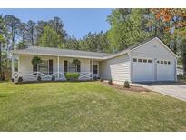 Charming one-story home with a well-manicured lawn and attached two-car garage at 2939 Owens Point Nw Trl, Kennesaw, GA 30152