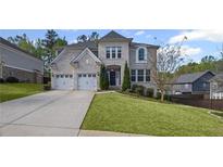 Stunning two-story home featuring a lush green lawn, a concrete driveway, and a two-car garage at 5153 Elkins Ln, Acworth, GA 30101