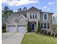 Charming two-story home with a manicured lawn and a two-car garage at 5153 Elkins Ln, Acworth, GA 30101