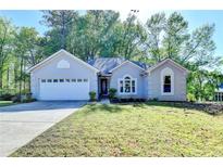 Charming one-story home with a two car garage and well-maintained landscaping at 4640 Lambton Cir, Suwanee, GA 30024