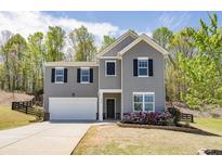 Charming two-story home featuring a gray exterior and well-maintained landscaping at 4740 Alford Commons, Cumming, GA 30028