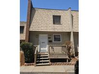 Two-story townhome exterior with brown siding and wooden deck at 6433 Stone Way, Morrow, GA 30260