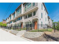 Modern townhomes showcasing clean architectural lines, large windows, and fenced front yards at 1300 Memorial Se Dr # 12, Atlanta, GA 30317