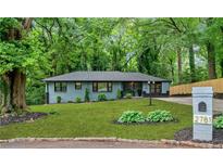 Charming home with mature trees, freshly cut lawn, and updated landscaping at 2781 Long Way, Decatur, GA 30032