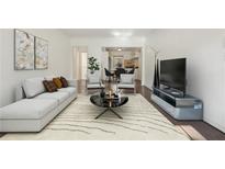 Bright living room with large windows, comfortable seating, and hardwood floors at 55 Delmont Ne Dr # D1, Atlanta, GA 30305
