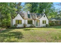 Charming white brick home featuring a well-manicured lawn and classic architectural details at 1027 Mount Airy Sw Dr, Atlanta, GA 30311