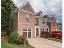 Charming brick front home with attached garage, landscaped yard and a traditional architectural design at 5260 Sherwood Way, Cumming, GA 30040