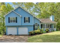 Charming two-story home with a two-car garage and a manicured lawn at 111 Amberwood Ln, Euharlee, GA 30145